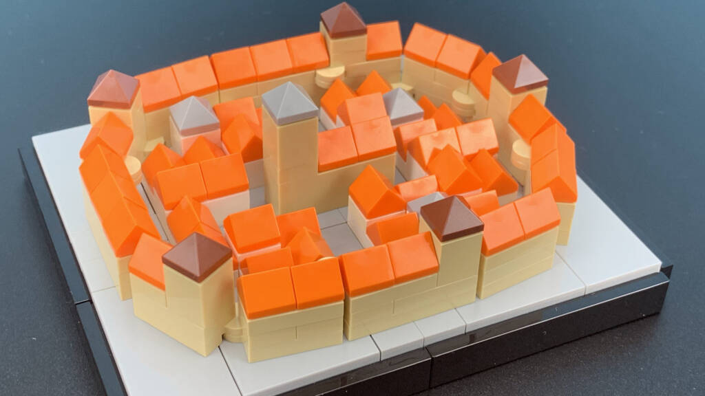 LEGO MOC orange and beige circular wall with gray platforms, bricks arranged around an inner courtyard.