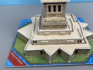 Statue of Liberty miniature, detailed base on a blue display platform with “Statue of Liberty” text label