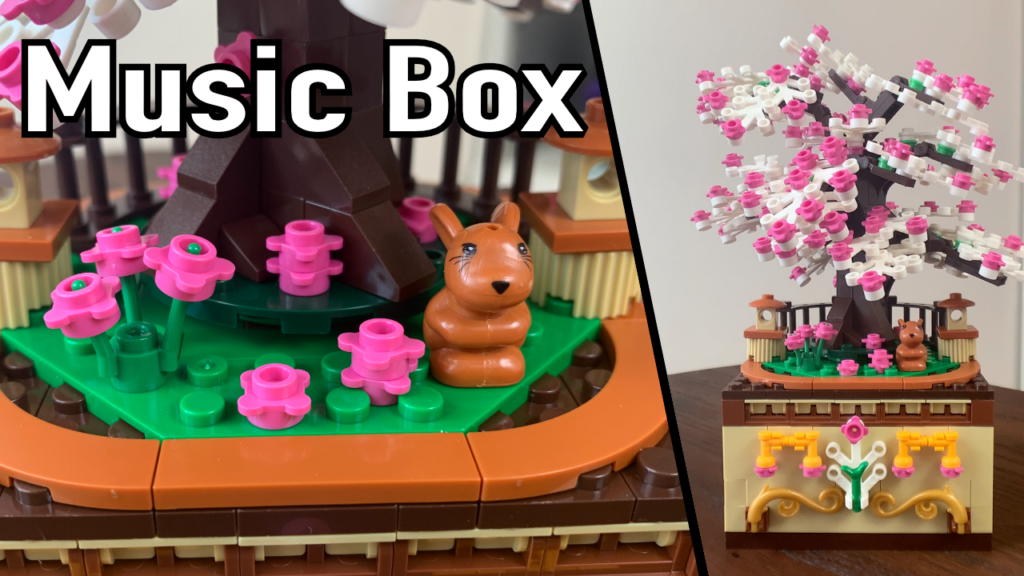 Music Box toy with colorful LEGO bricks and a small cat figure on a rotating music mechanism