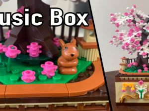 Music Box toy with colorful LEGO bricks and a small cat figure on a rotating music mechanism