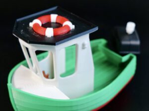 Toy fire station nozzle turret with red-and-white lifebuoy detail on a green ship-like vehicle